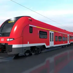 Ein roter Desiro HC Zug der Deutschen Bahn fährt auf den Gleisen.